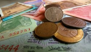 Closeup overhead shot of coins  and banknotes displaying Indian currency of various values